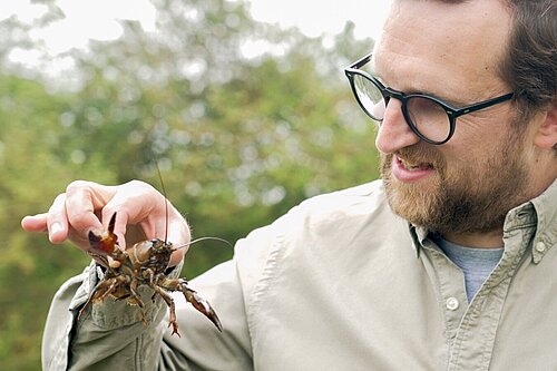 Freddie holding a crayfish