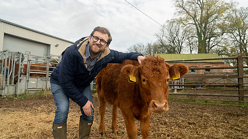 Henley & Thame MP Freddie van Mierlo standing next to a brown calf