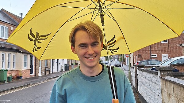 Theo with lib dem umbrella